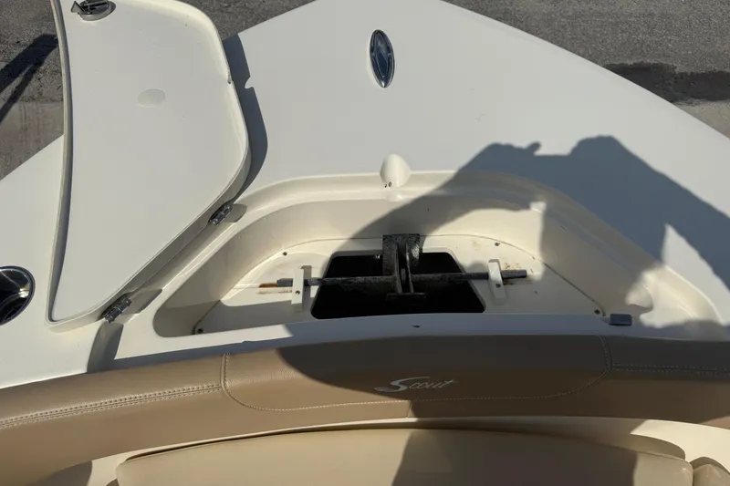 Slide: The Image of 2023 Scout 215 XSF boat bow storage compartment with open hatch. - 49