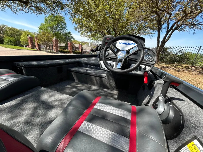 Slide: The Image of 2023 Ranger RT178 boat interior with steering wheel and seating, under sunny skies. - 12