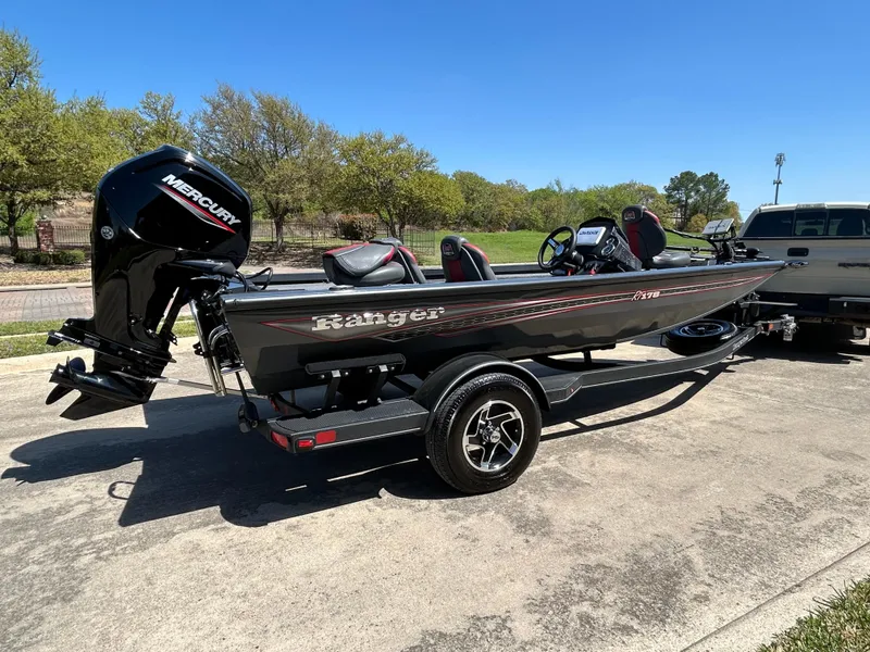 Slide: The Image of 2023 Ranger RT178 boat with Mercury engine on trailer, parked outdoors. - 13