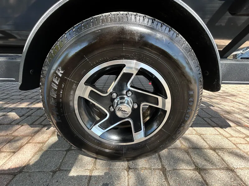 Slide: The Image of 2023 Ranger RT178 wheel with black and silver alloy rim on a paved surface. - 18
