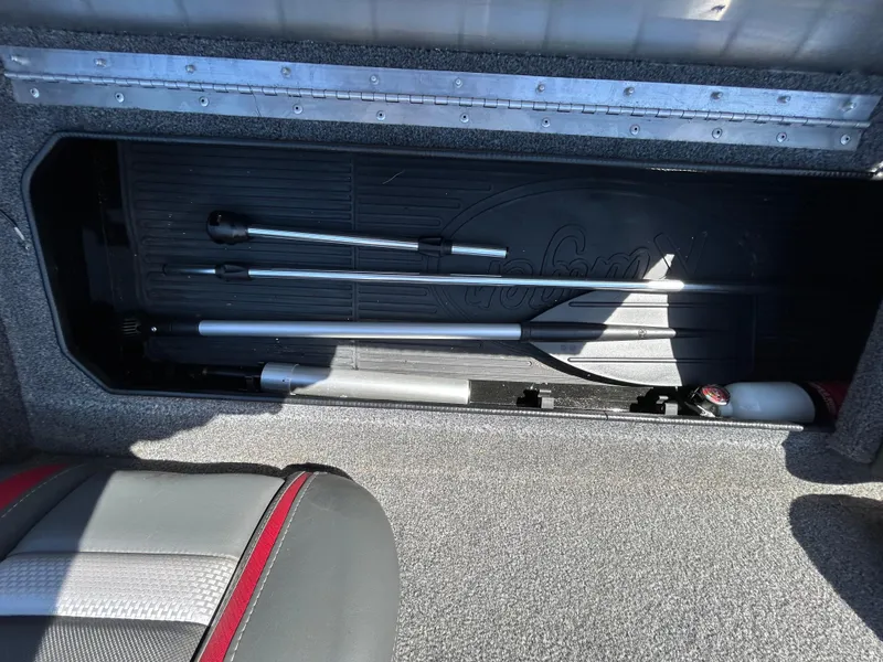 Slide: The Image of 2023 Ranger RT178 storage compartment with fishing rods and equipment. - 25