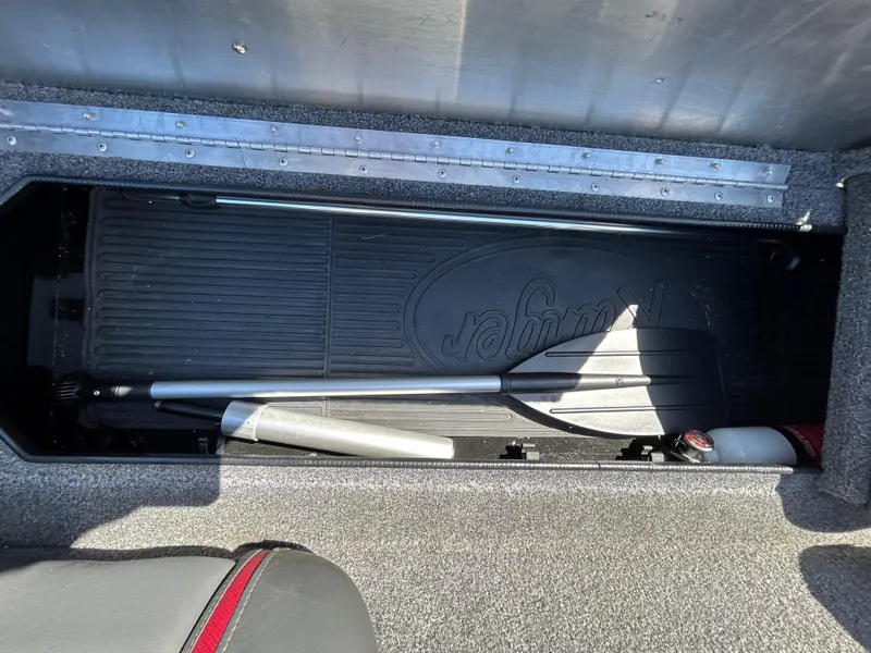 Slide: The Image of 2023 Ranger RT178 storage compartment with paddle and fire extinguisher. - 26
