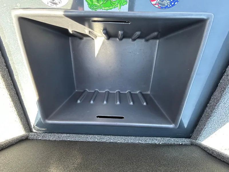 Slide: The Image of 2023 Ranger RT178 storage compartment with textured interior and stickers on the lid. - 28