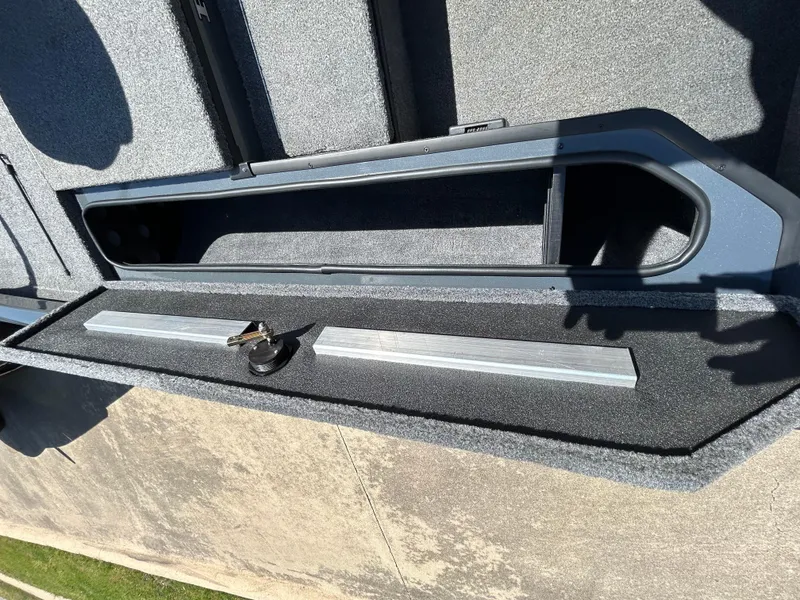 Slide: The Image of 2023 Ranger RT178 boat storage compartment with keys and metal bar inside. - 29