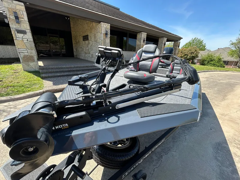 Slide: The Image of 2023 Ranger RT178 fishing boat parked outside a building on a sunny day. - 3