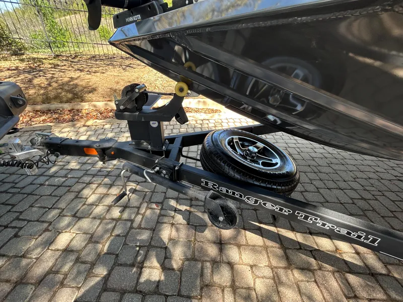 Slide: The Image of 2023 Ranger RT178 boat trailer with spare tire on cobblestone pavement. - 36