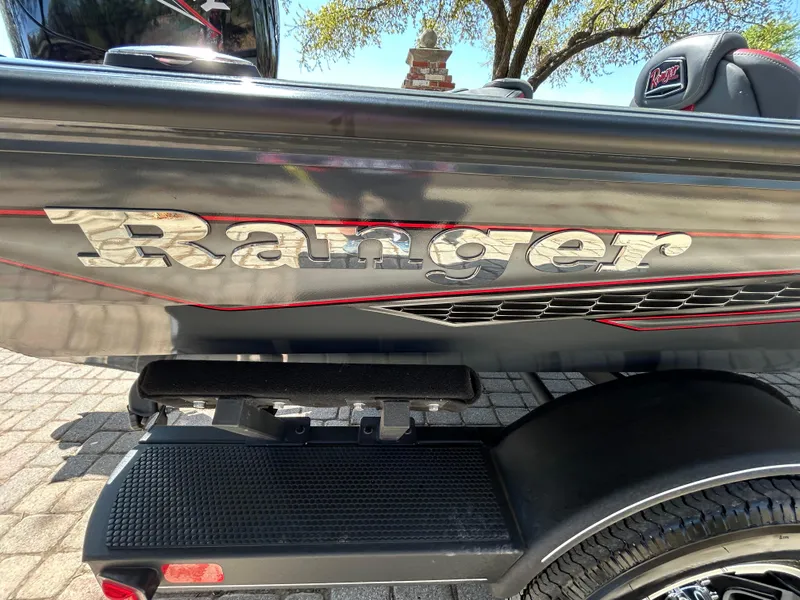 Slide: The Image of 2023 Ranger RT178 boat with logo, sleek design, and black and red accents. - 37