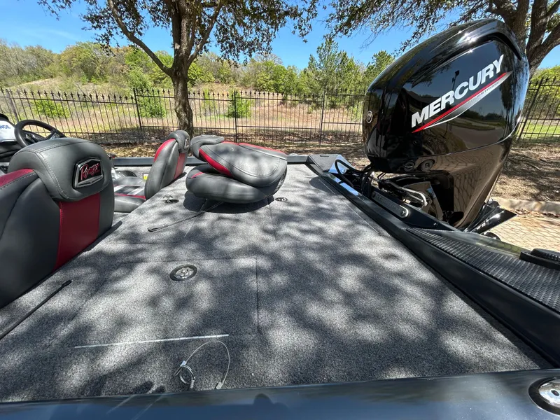 Slide: The Image of 2023 Ranger RT178 boat with Mercury engine, featuring spacious deck and seating under trees. - 38