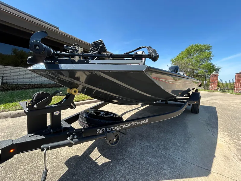 Slide: The Image of 2023 Ranger RT178 boat on trailer, parked outdoors under clear blue sky. - 4