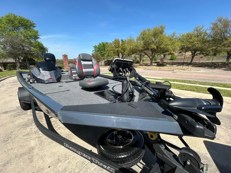 Slide: The Image of 2023 Ranger RT178 fishing boat on trailer, parked outdoors under clear blue sky. - 7