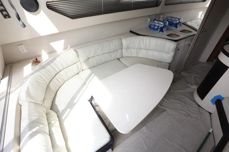 Slide: The Image of 1989 Carver 30 Santego interior with white leather seating and table. - 13