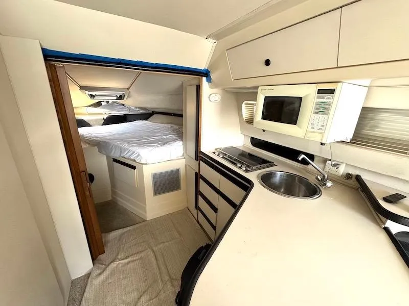 Slide: The Image of Interior of 1989 Carver 30 Santego yacht with kitchenette and sleeping area. - 14
