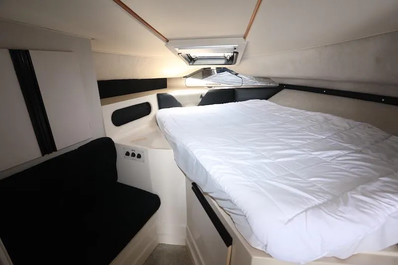 Slide: The Image of 1989 Carver 30 Santego cabin interior with bed and seating, featuring modern design elements. - 18