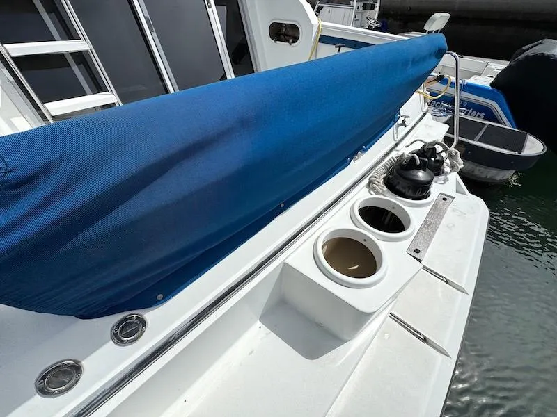 Slide: The Image of 1989 Carver 30 Santego boat deck with blue cover and cup holders. - 4