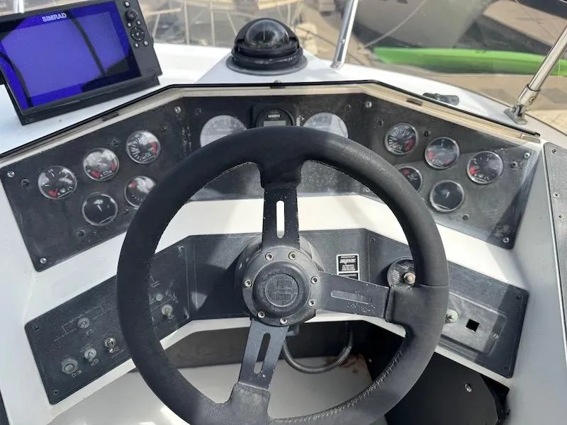 Slide: The Image of 1989 Carver 30 Santego boat dashboard with steering wheel and navigation instruments. - 5