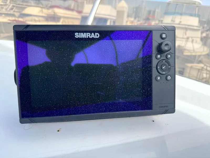Slide: The Image of Simrad marine display on 1989 Carver 30 Santego boat, docked with other vessels. - 7