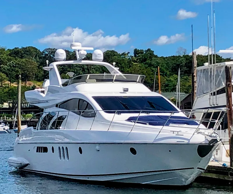 The Image of Luxury 2002 Azimut 55 yacht docked in a scenic marina setting. - 0