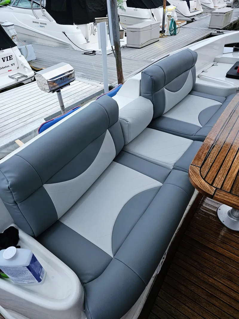 Slide: The Image of Luxurious seating on a 2002 Azimut 55 yacht, featuring gray and white upholstery. - 14