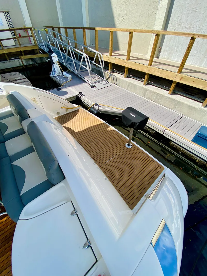 Slide: The Image of Azimut 55 yacht, 2002 model, docked with wooden deck and seating area. - 15