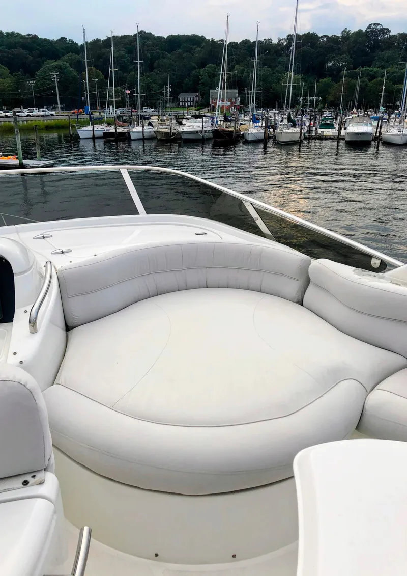 Slide: The Image of Luxurious 2002 Azimut 55 yacht with spacious white seating, docked in a scenic marina. - 22