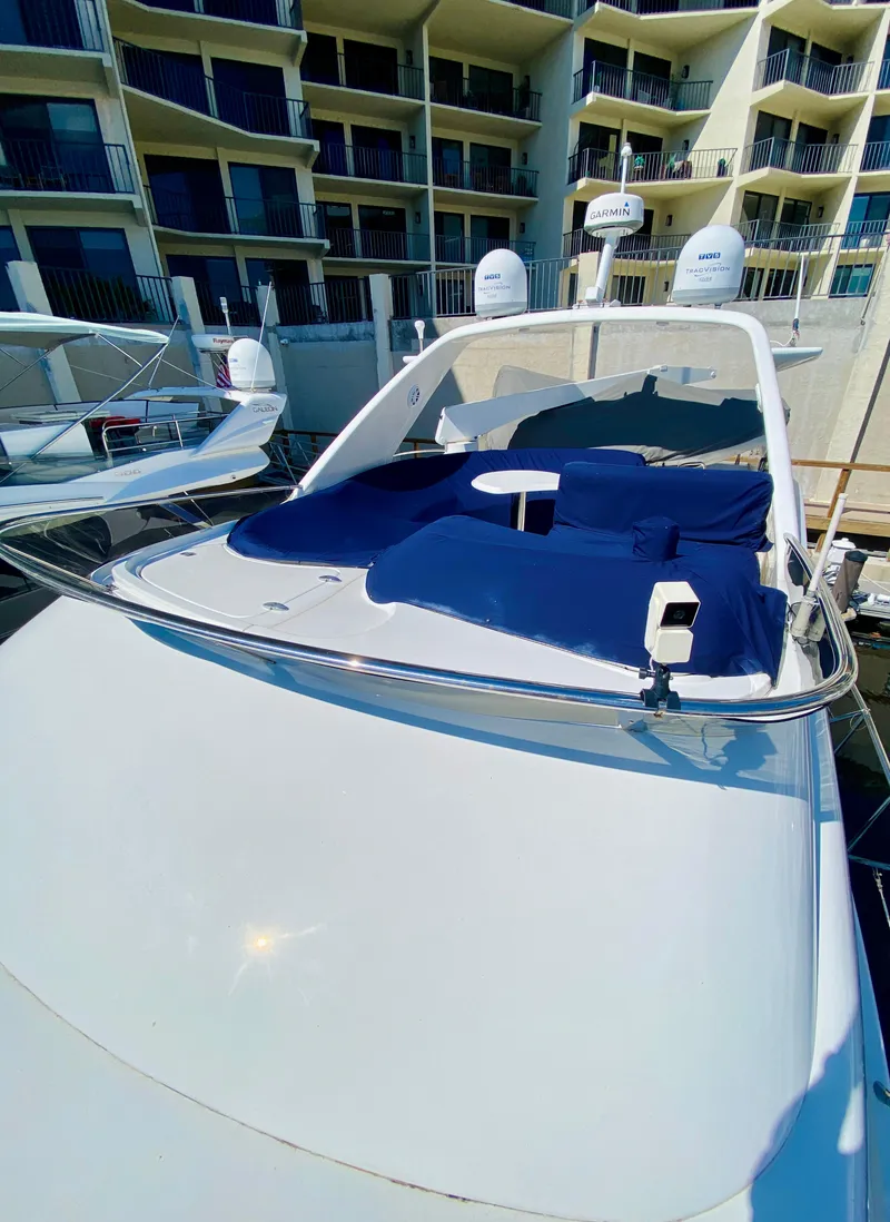 Slide: The Image of Azimut 55 yacht, 2002 model, docked with blue sunbathing area, modern design. - 28