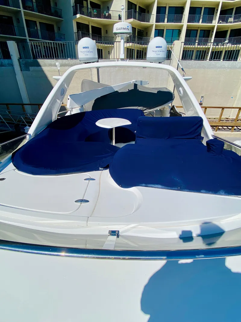 Slide: The Image of 2002 Azimut 55 yacht with blue sunbathing cushions and modern design. - 29