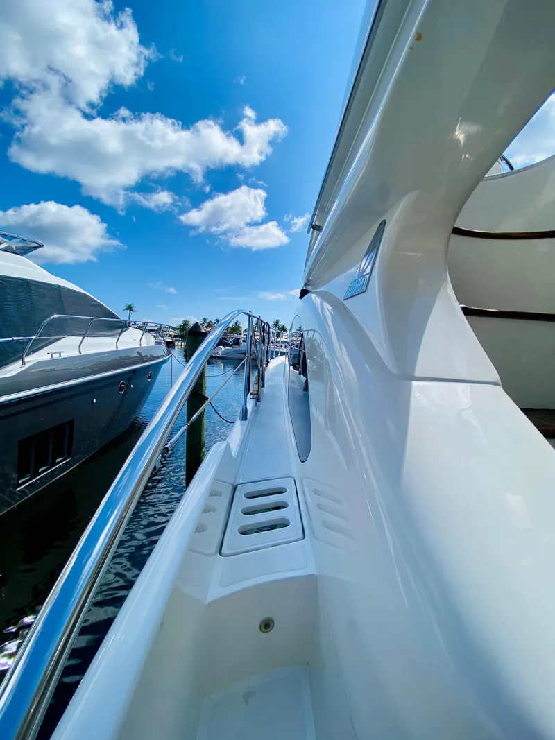 Slide: The Image of Side view of a 2002 Azimut 55 yacht with sleek design and clear blue sky. - 33