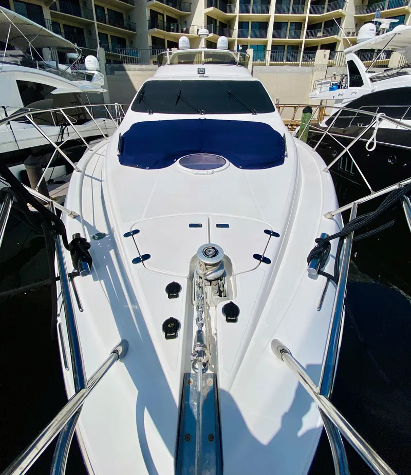 Slide: The Image of 2002 Azimut 55 yacht docked at marina, showcasing sleek design and spacious deck. - 36