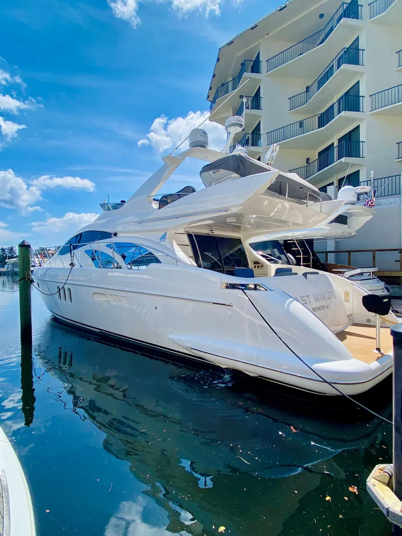 Slide: The Image of Luxury 2002 Azimut 55 yacht docked beside waterfront building. - 4
