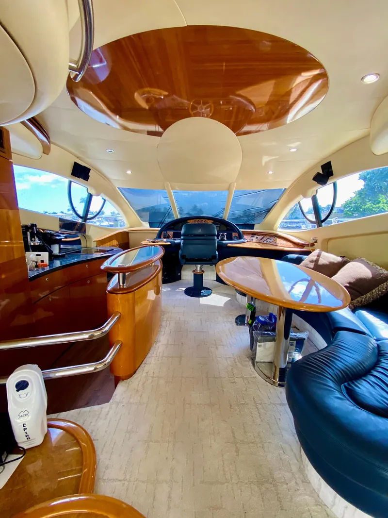Slide: The Image of Luxurious interior of a 2002 Azimut 55 yacht with elegant wood finishes and modern seating. - 41