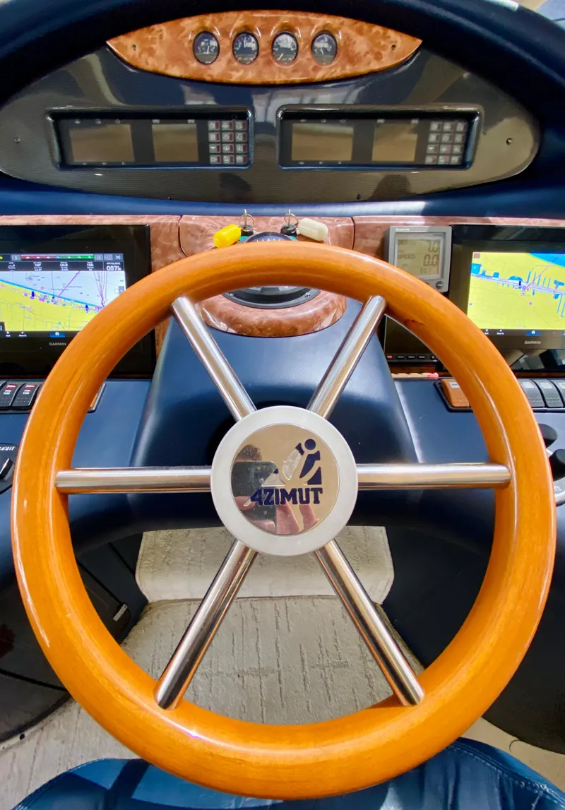 Slide: The Image of Steering wheel of a 2002 Azimut 55 yacht with navigation displays. - 49