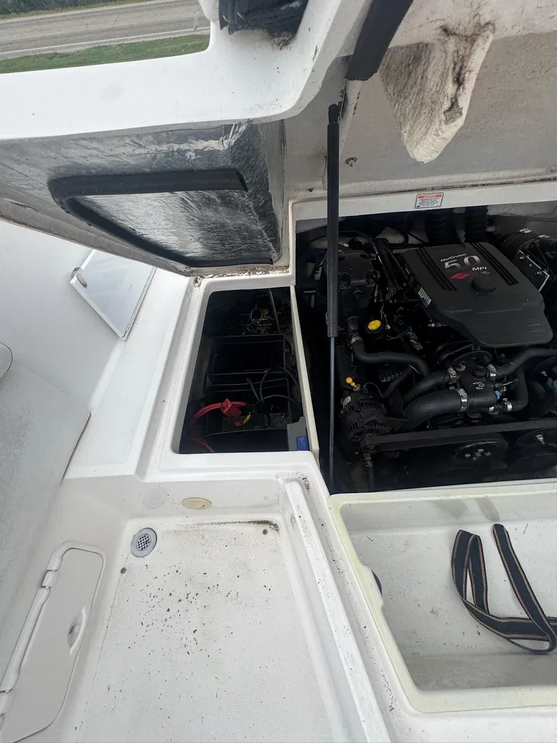 Slide: The Image of Open engine compartment of a 2007 Regal 2000 Bowrider boat, showing engine details. - 10