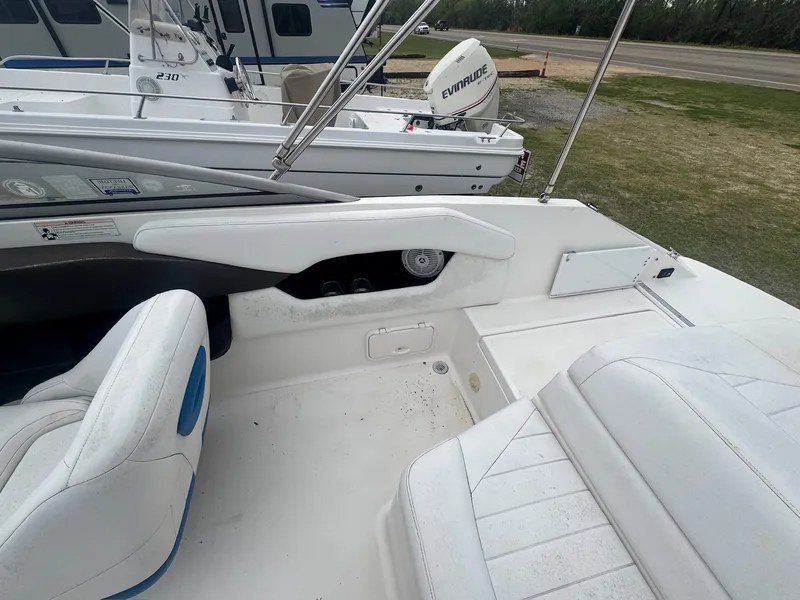 Slide: The Image of 2007 Regal 2000 Bowrider interior with white seating and nearby boat in background. - 6