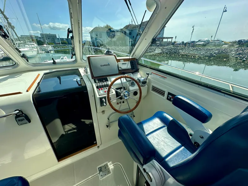 Slide: The Image of 2008 Back Cove 33 Express helm with blue captain's chair and navigation equipment. - 19