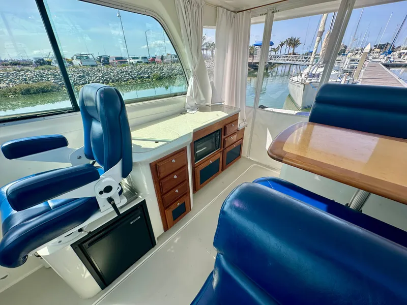 Slide: The Image of Interior of 2008 Back Cove 33 Express yacht with blue seating and wooden cabinetry. - 21