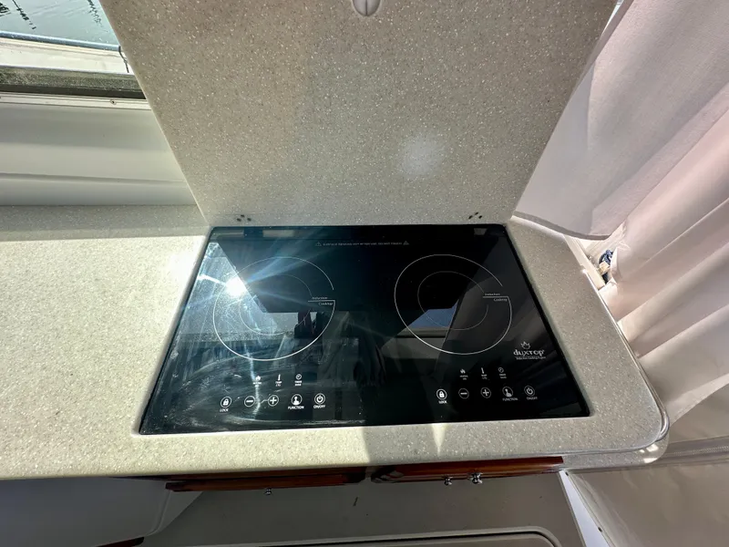 Slide: The Image of Induction cooktop on 2008 Back Cove 33 Express yacht kitchen counter. - 22