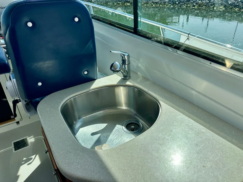Slide: The Image of 2008 Back Cove 33 Express boat interior with sink and blue seat. - 23