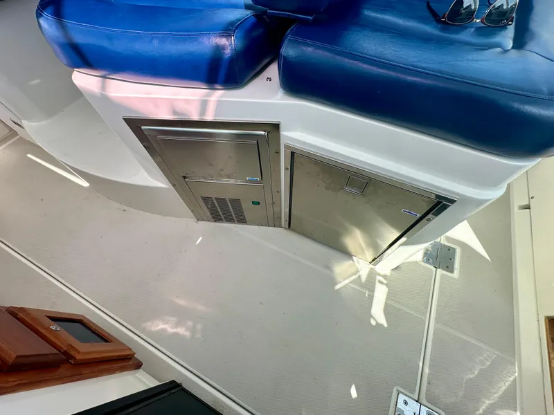 Slide: The Image of 2008 Back Cove 33 Express interior with blue seating and stainless steel appliances. - 24