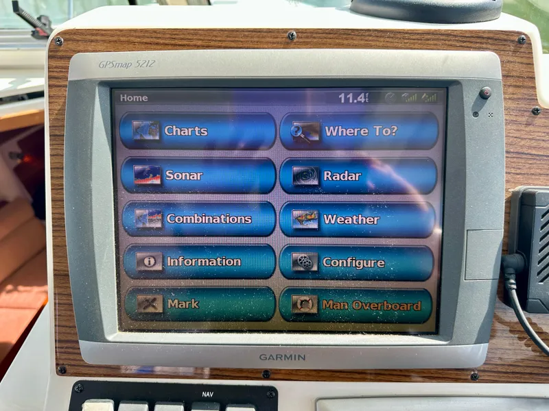 Slide: The Image of Garmin GPS display on 2008 Back Cove 33 Express boat, showing navigation and weather options. - 28