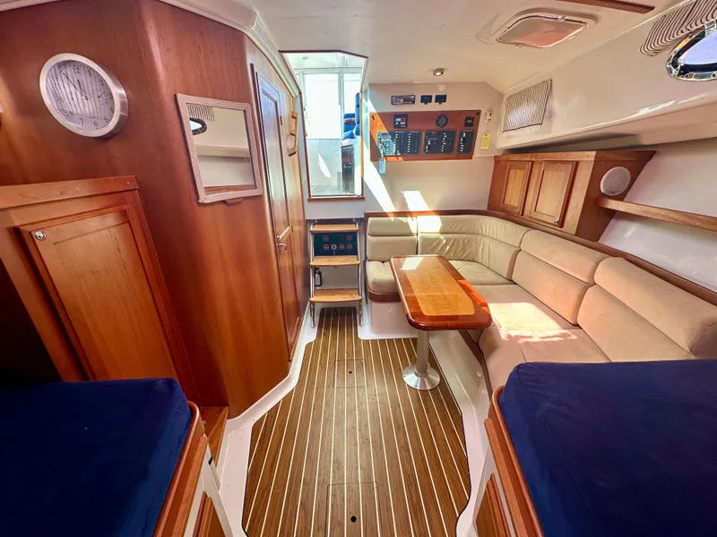 Slide: The Image of Interior of 2008 Back Cove 33 Express yacht with wood paneling and beige seating. - 38