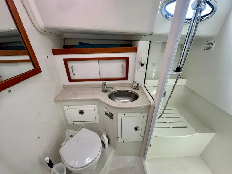 Slide: The Image of 2008 Back Cove 33 Express boat bathroom with sink, toilet, and shower. - 39