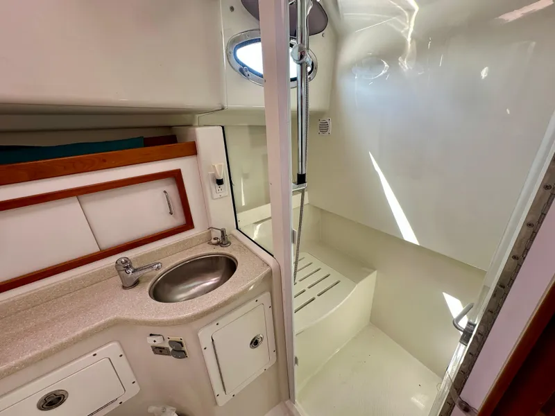 Slide: The Image of 2008 Back Cove 33 Express bathroom with sink, shower, and storage cabinets. - 40