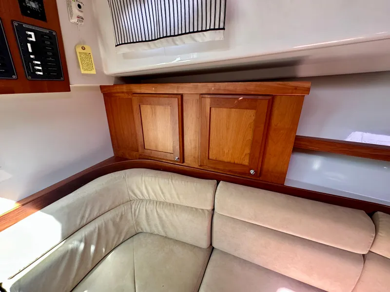 Slide: The Image of 2008 Back Cove 33 Express interior with beige seating and wooden cabinetry. - 42