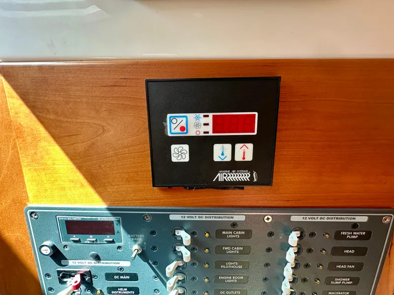 Slide: The Image of Control panel of a 2008 Back Cove 33 Express boat, featuring various switches and indicators. - 43
