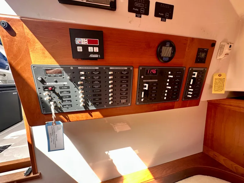 Slide: The Image of Electrical control panel on a 2008 Back Cove 33 Express boat, featuring switches and gauges. - 44