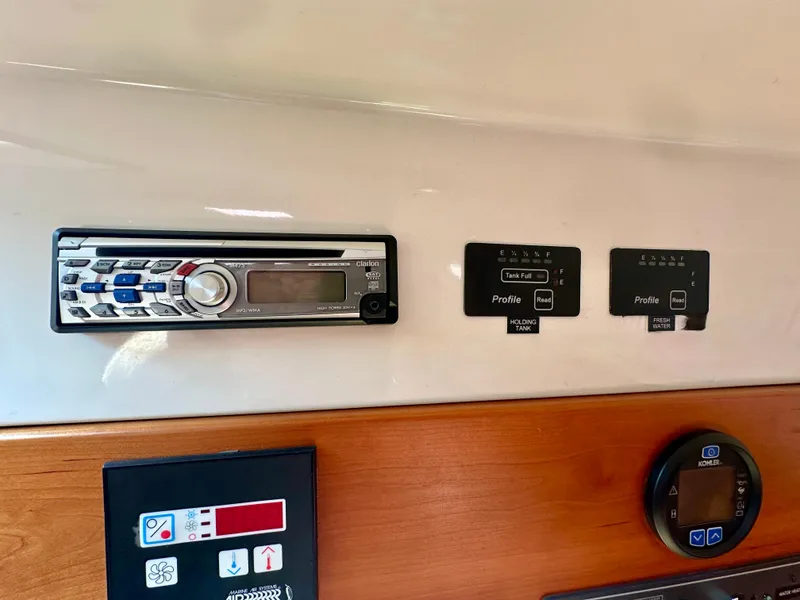 Slide: The Image of Control panel of a 2008 Back Cove 33 Express boat with stereo and gauges. - 45