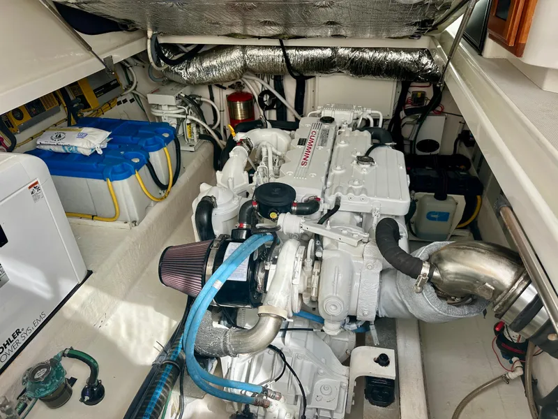 Slide: The Image of Engine room of a 2008 Back Cove 33 Express boat, featuring a clean and organized layout. - 49