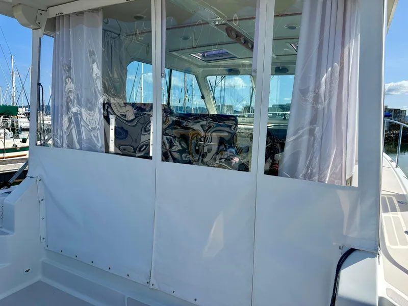 Slide: The Image of 2008 Back Cove 33 Express boat with enclosed cabin and marina view. - 9