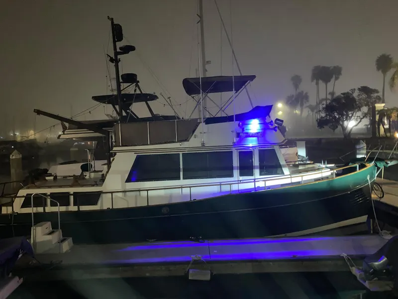 Slide: The Image of 1985 Grand Banks 42 Classic yacht docked at night with blue lights. - 10