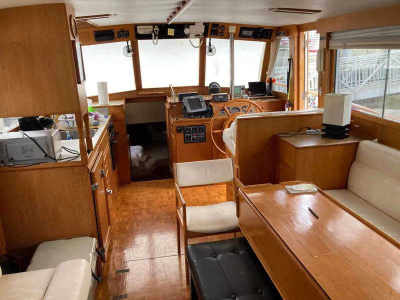 Slide: The Image of Interior of 1985 Grand Banks 42 Classic yacht, featuring wood paneling and navigation equipment. - 15